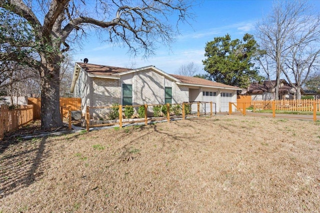 rear view of house featuring fence, a lawn, and brick siding