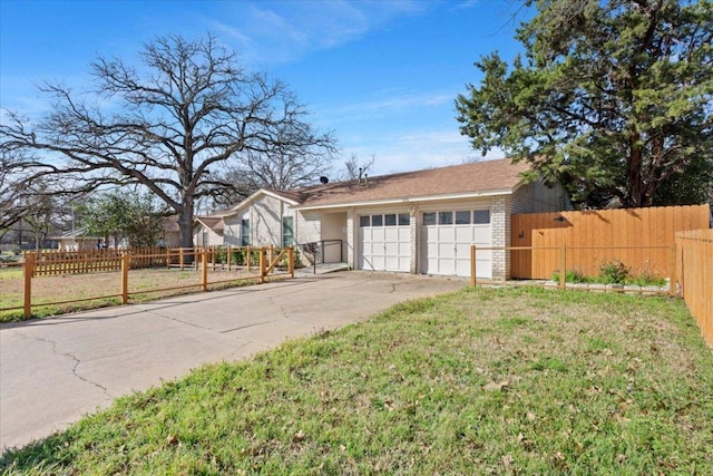 exterior space with a garage, concrete driveway, brick siding, and fence