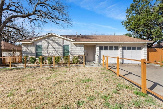 ranch-style house with a garage, brick siding, fence, and a front lawn