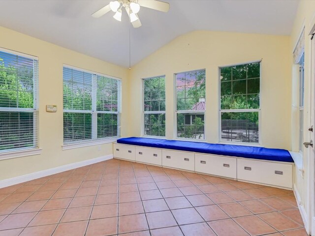 unfurnished sunroom featuring ceiling fan and lofted ceiling