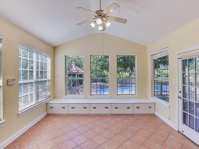 unfurnished sunroom featuring a ceiling fan and vaulted ceiling