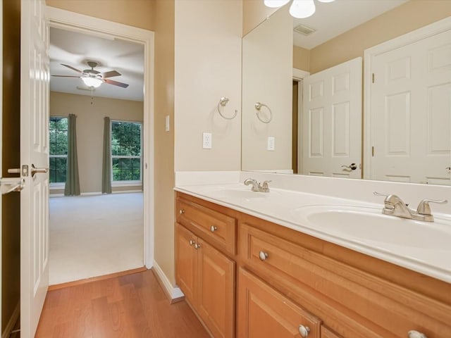 bathroom with ceiling fan, double vanity, visible vents, and a sink