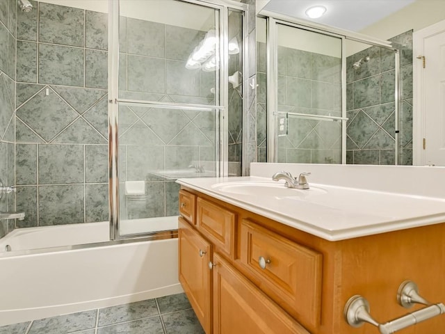 bathroom featuring combined bath / shower with glass door, vanity, and tile patterned flooring