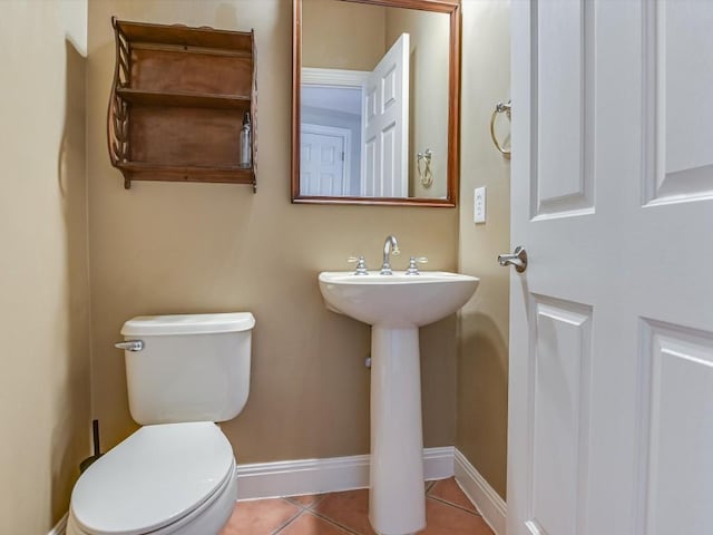 6 Wingreen Loop, The Hills, TX 78738 - half bath featuring tile patterned flooring, toilet, baseboards, and a sink