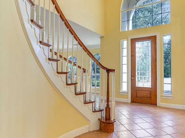 6 Wingreen Loop, The Hills, TX 78738 - entryway with plenty of natural light, a high ceiling, baseboards, tile patterned flooring, and stairs