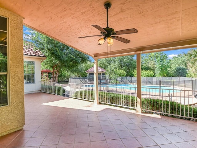 view of patio / terrace with a fenced in pool, ceiling fan, and fence