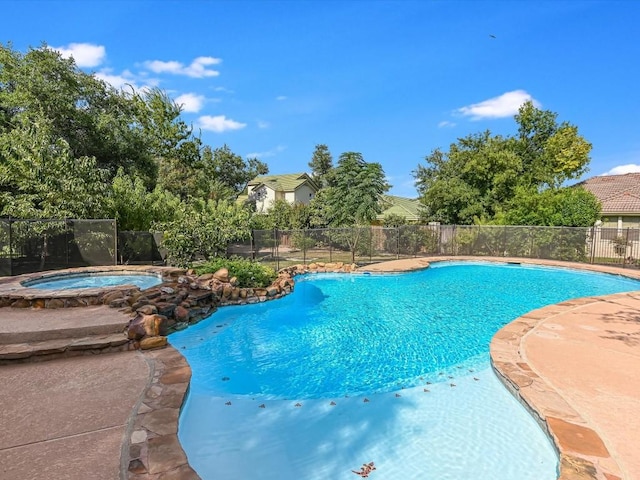 view of pool with a fenced in pool, a patio, an in ground hot tub, and fence