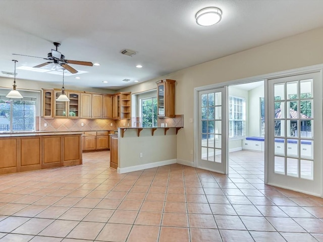 kitchen featuring decorative backsplash, open shelves, and light tile patterned flooring