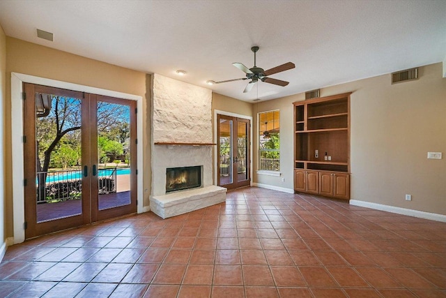 6 Wingreen Loop, The Hills, TX 78738 - unfurnished living room with french doors, baseboards, built in features, tile patterned floors, and ceiling fan