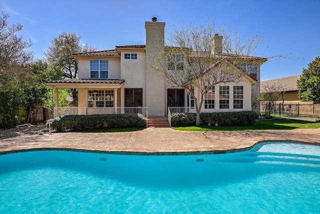 6 Wingreen Loop, The Hills, TX 78738 - back of property with stucco siding, a chimney, and a tile roof