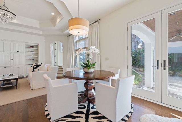 dining room featuring a wealth of natural light, arched walkways, dark wood-type flooring, and french doors