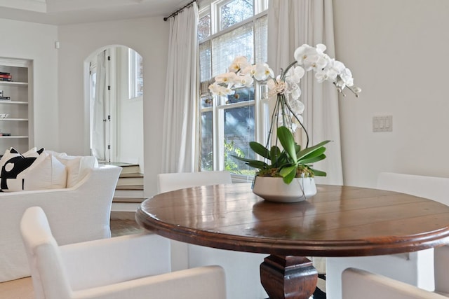 dining area featuring arched walkways