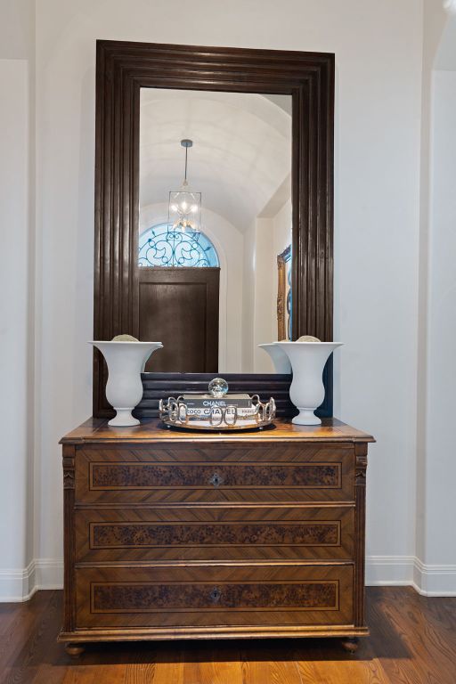 details featuring a notable chandelier, baseboards, and wood finished floors