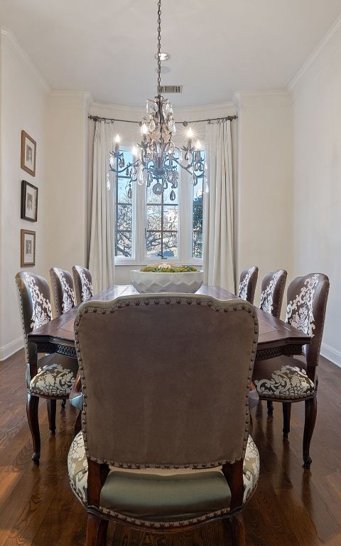 dining space featuring ornamental molding, a chandelier, dark wood finished floors, and baseboards