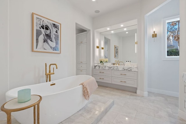 full bath with recessed lighting, a freestanding tub, vanity, and baseboards