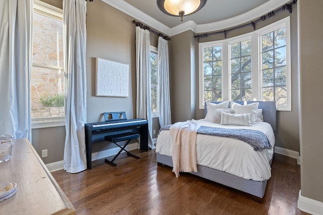 bedroom with baseboards, dark wood-style flooring, and crown molding