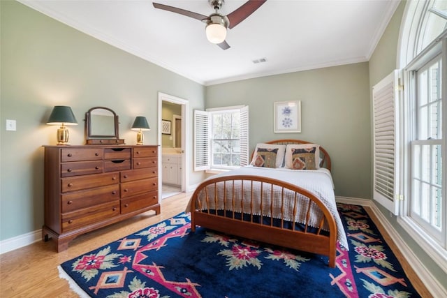 bedroom featuring baseboards, connected bathroom, ceiling fan, crown molding, and light wood-style floors