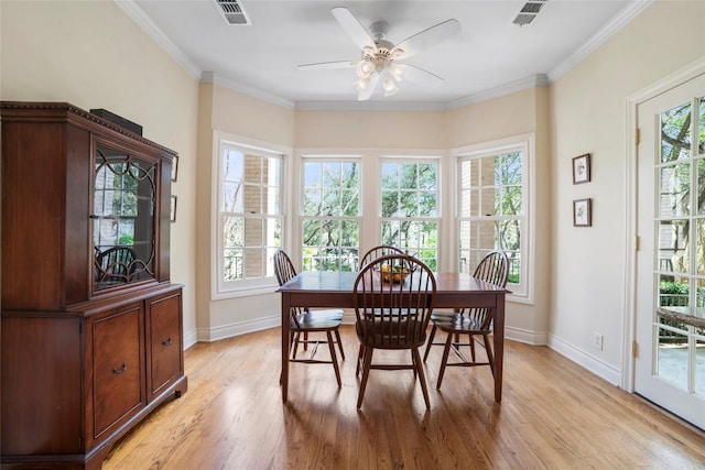 dining space with baseboards, visible vents, and light wood finished floors