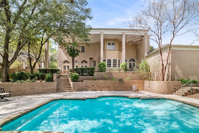 pool with stairs and a patio