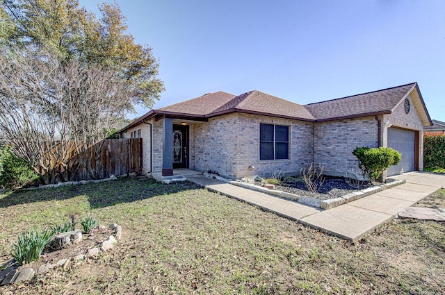 single story home with a garage, a shingled roof, fence, a front yard, and brick siding