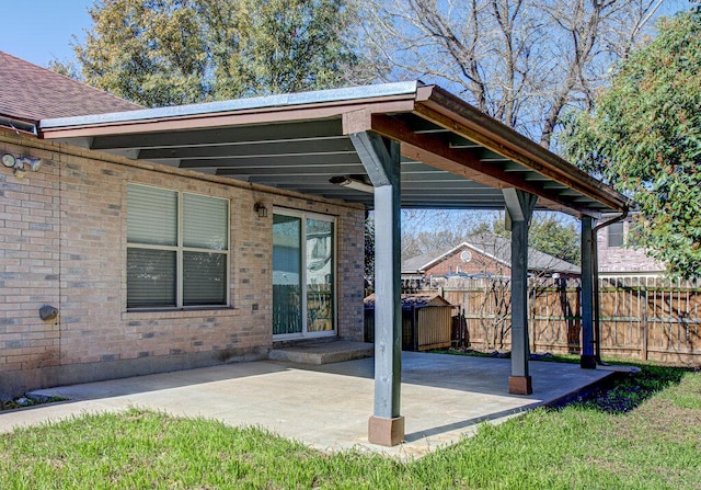 view of patio / terrace with a carport and fence