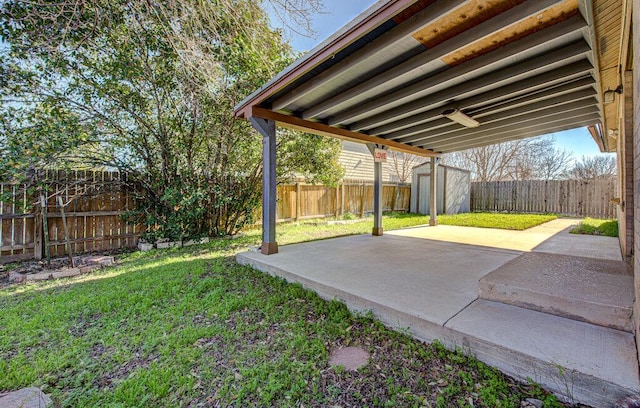 view of yard with a patio area, an outdoor structure, a fenced backyard, and a shed