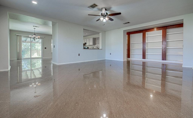 unfurnished living room featuring ceiling fan with notable chandelier, visible vents, and baseboards