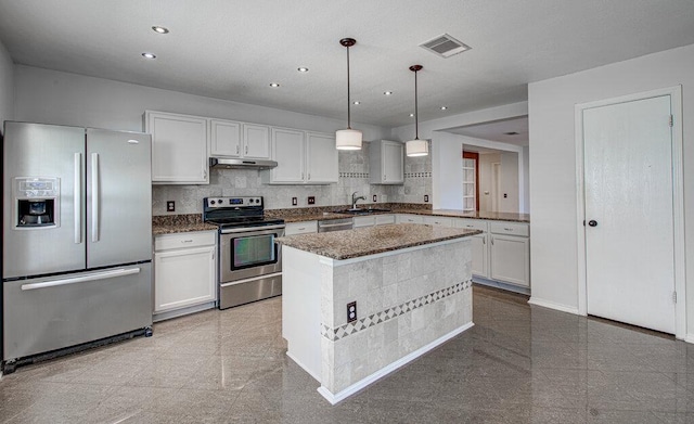 kitchen featuring stainless steel appliances, recessed lighting, granite finish floor, and under cabinet range hood