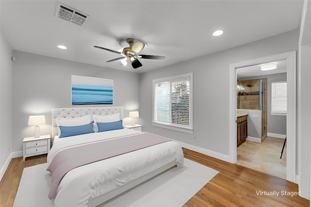 bedroom with light wood-style floors, visible vents, baseboards, and multiple windows