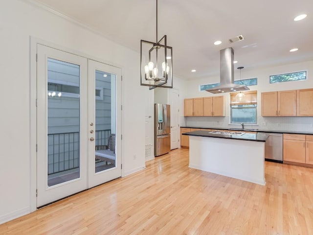 kitchen with island range hood, visible vents, dark countertops, appliances with stainless steel finishes, and light brown cabinets