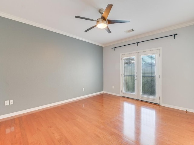 spare room featuring baseboards, visible vents, french doors, and ornamental molding