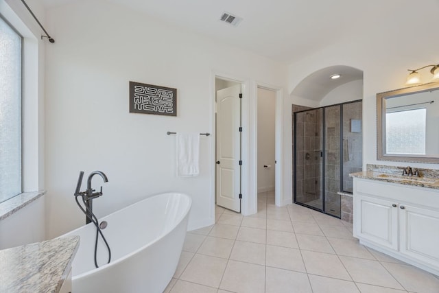 bathroom with a stall shower, visible vents, tile patterned floors, a freestanding bath, and vanity