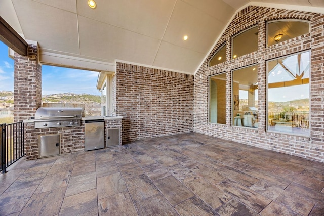 view of patio featuring a grill and an outdoor kitchen