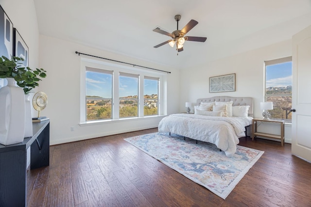 bedroom with dark wood finished floors, baseboards, and ceiling fan