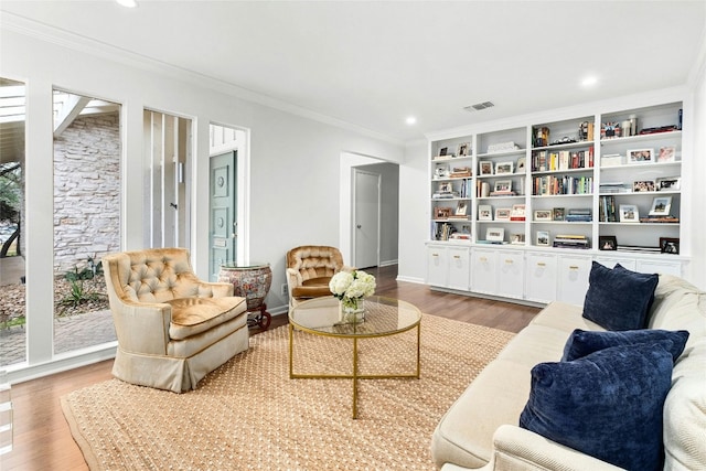 living area with recessed lighting, visible vents, wood finished floors, and ornamental molding