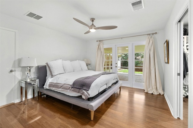 bedroom featuring access to outside, french doors, wood finished floors, and visible vents