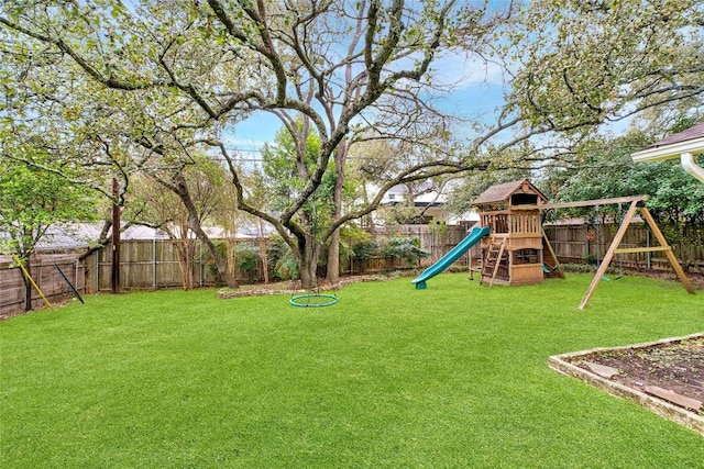 view of yard with a playground and a fenced backyard