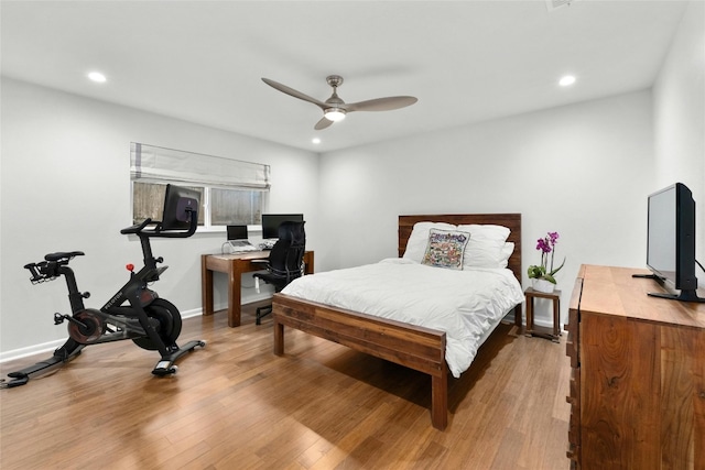 bedroom featuring baseboards, wood finished floors, and recessed lighting