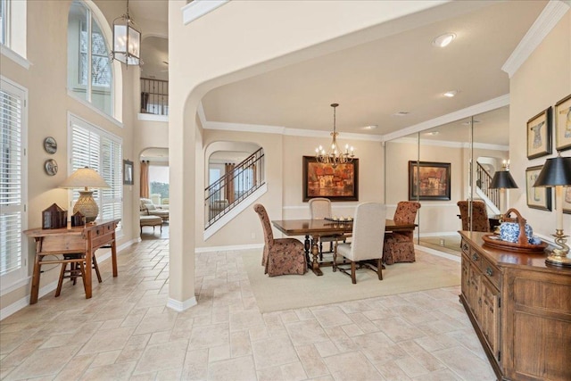 dining room featuring baseboards, stone finish floor, ornamental molding, stairs, and a notable chandelier