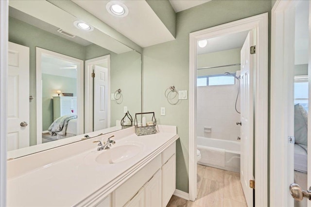 ensuite bathroom with visible vents, shower / bath combination, toilet, ensuite bathroom, and vanity