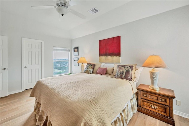 bedroom featuring a ceiling fan, baseboards, visible vents, and light wood finished floors