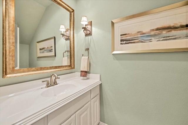 bathroom with lofted ceiling and vanity