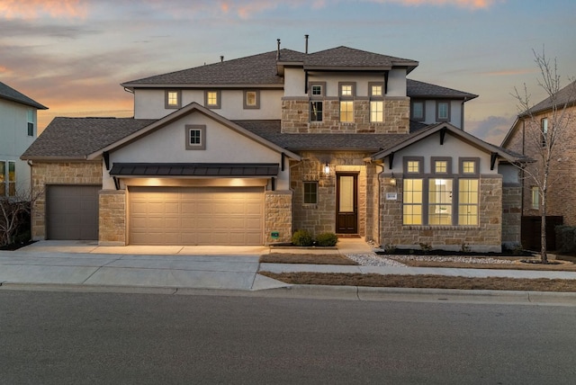 view of front of home with stone siding, driveway, a balcony, and an attached garage