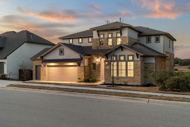 view of front of property with a garage, stone siding, and stucco siding