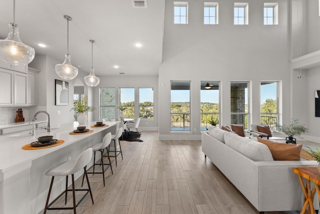 interior space featuring light wood-style floors, recessed lighting, visible vents, and baseboards