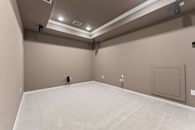 carpeted spare room with baseboards, a tray ceiling, ornamental molding, and recessed lighting