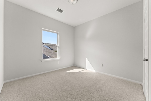 carpeted empty room featuring visible vents and baseboards