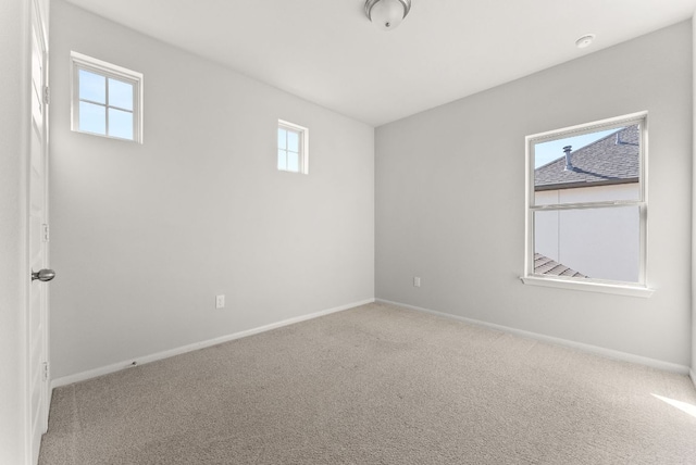 carpeted empty room with baseboards