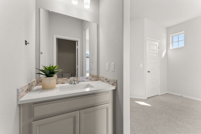 bathroom featuring baseboards and vanity