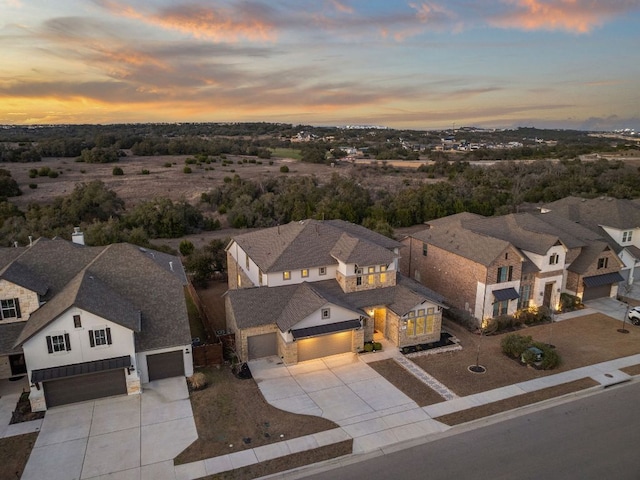 aerial view at dusk featuring a residential view